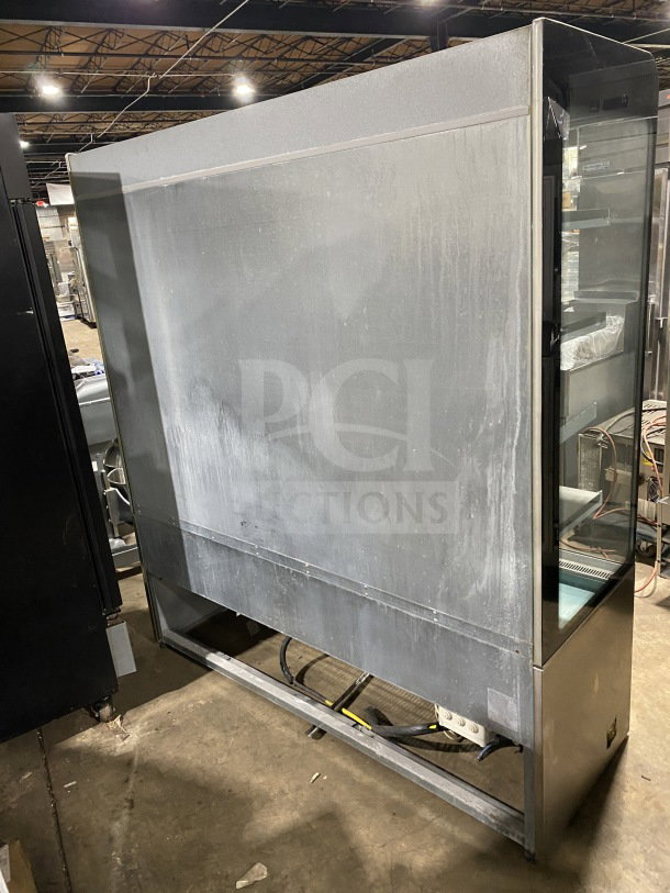 Commercial stainless-steel open-air merchandiser, electric powered, used condition, features glass display and internal shelving.