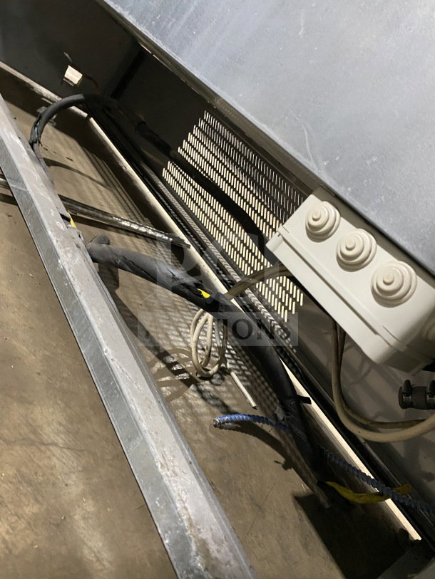 Commercial stainless steel open-air merchandiser, electric powered, shown from beneath. Wiring and vent details visible.
