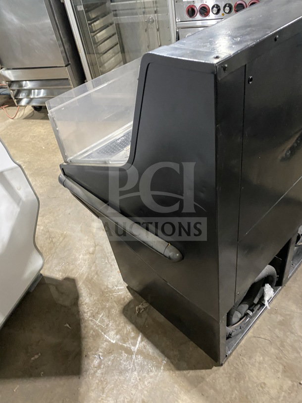Hussmann commercial self-contained open-air specialty merchandiser, 115V, black finish, transparent display, used condition.
