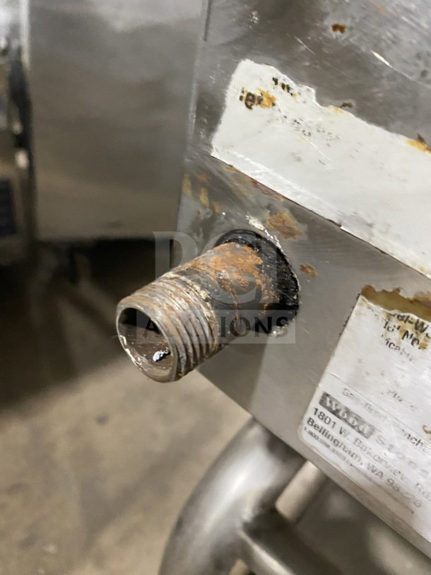 AccuTemp Accu-Steam stainless-steel griddle, gas-powered, mounted on rolling utility stand, visible wear and rust on connector.