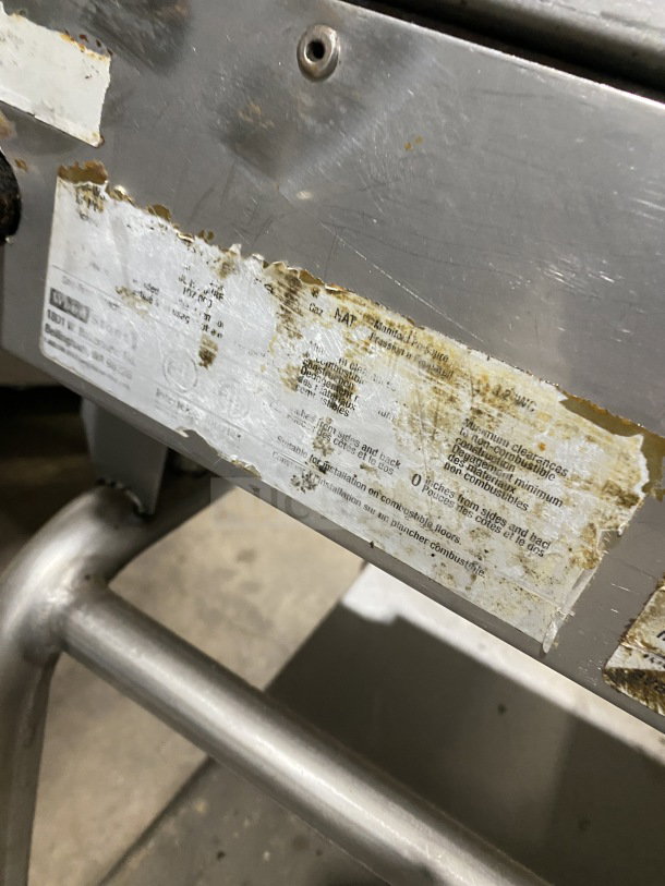 AccuTemp Accu-Steam stainless-steel flat-top griddle on rolling stand, gas powered. Visible wear and label details.