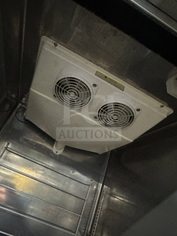 Everest commercial stainless steel freezer, model EBF1, includes poly coated wire rack, on casters, interior view.