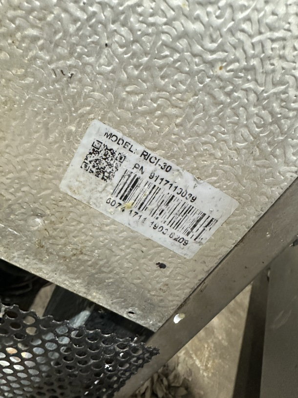 Universal Coolers Model RICI-30 stainless steel reach-in cooler, featuring a poly-coated wired rack, visible label with serial number 9117110089.