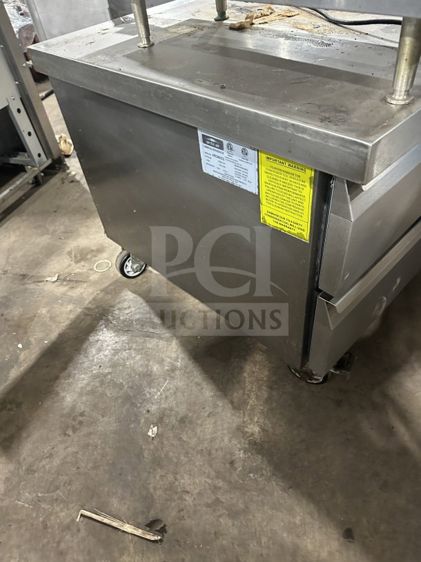 Arctic Air stainless steel 2-drawer refrigerated chef base model ARCB60CZ. Features visible labels and sits on casters.