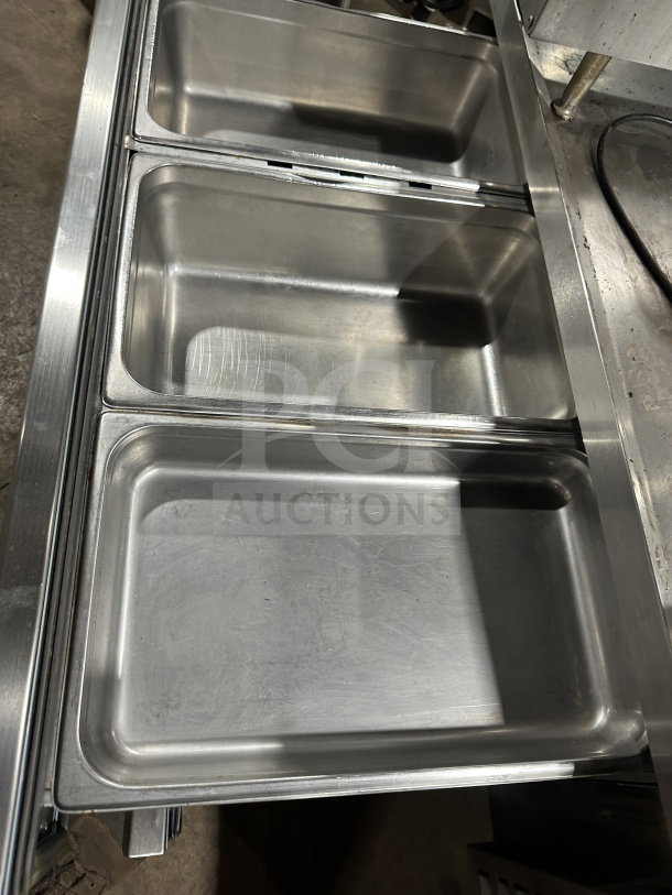 Arctic Air ARCB60CZ stainless steel 2-drawer refrigerated chef base, 62", with casters. Interior view showing drawers.