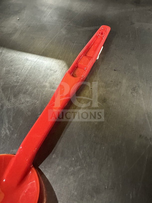Brand new Camwear red plastic spoon, 13 inches, model SPO13CW404, showing sturdy design; box contains 12.