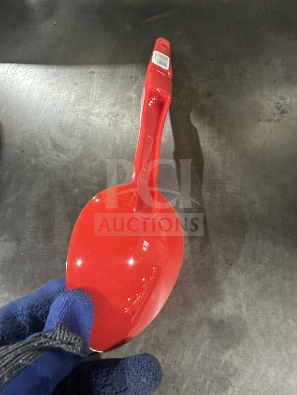Brand new Camwear commercial red plastic spoon, 13", model SPO13CW404, in pristine condition, visible label on handle.