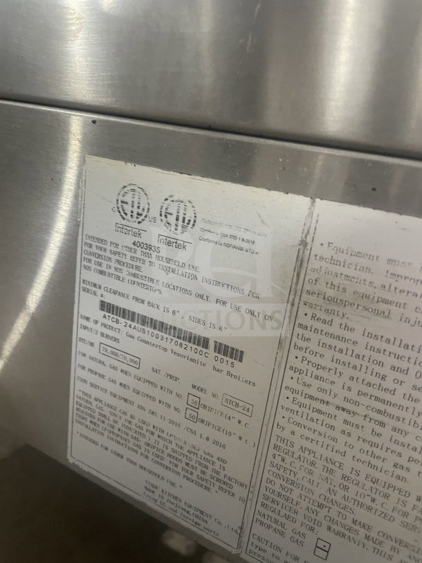 Atosa CookRite ATCB-24 stainless-steel char-rock broiler, gas powered, SN: 4003935, CSA certified label visible.