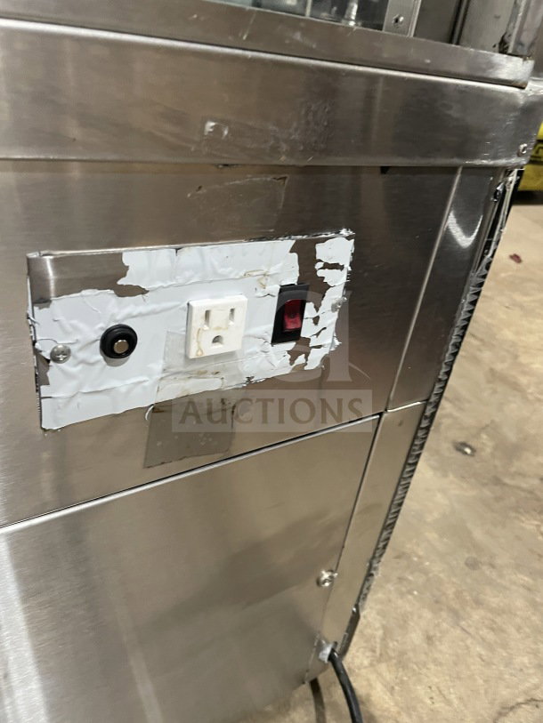 Refrigerated bakery/deli display case with poly coated wired rack, electrical components, and stainless steel finish.
