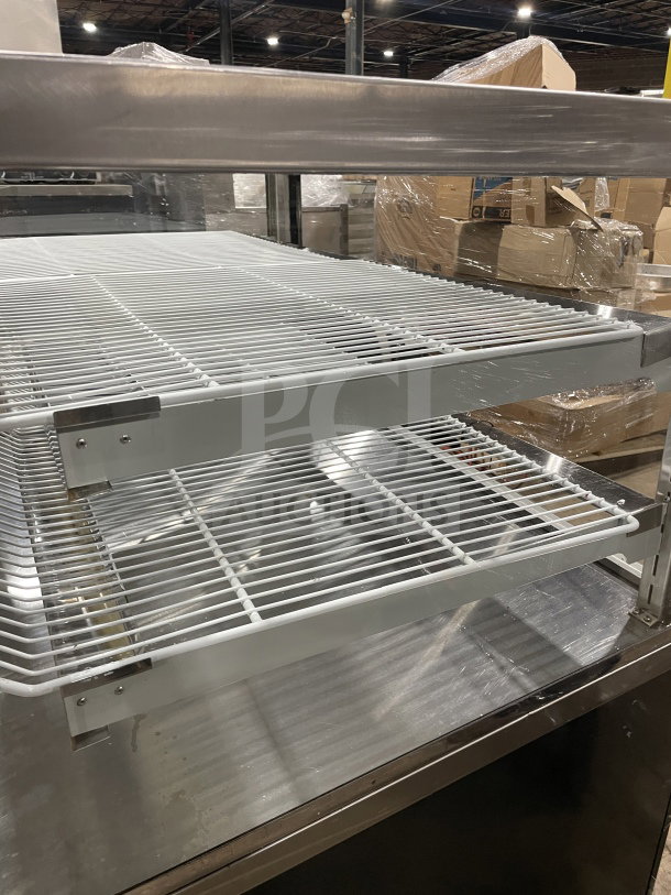 Commercial square glass refrigerated bakery/deli display case with poly-coated wire rack. Includes electrical powering.