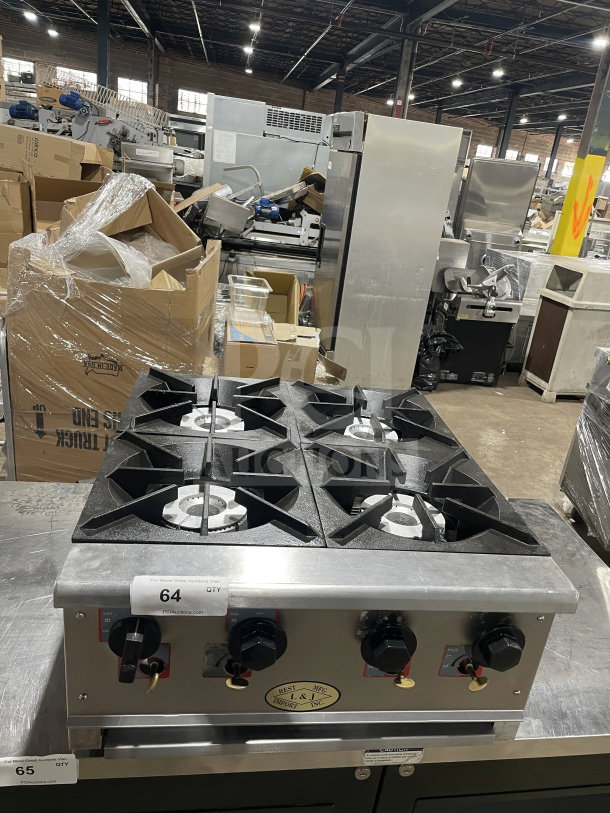 L&J Brands commercial stainless steel 4-burner gas hot plate. Features control knobs, sturdy grates. Marked with model and auction tags.