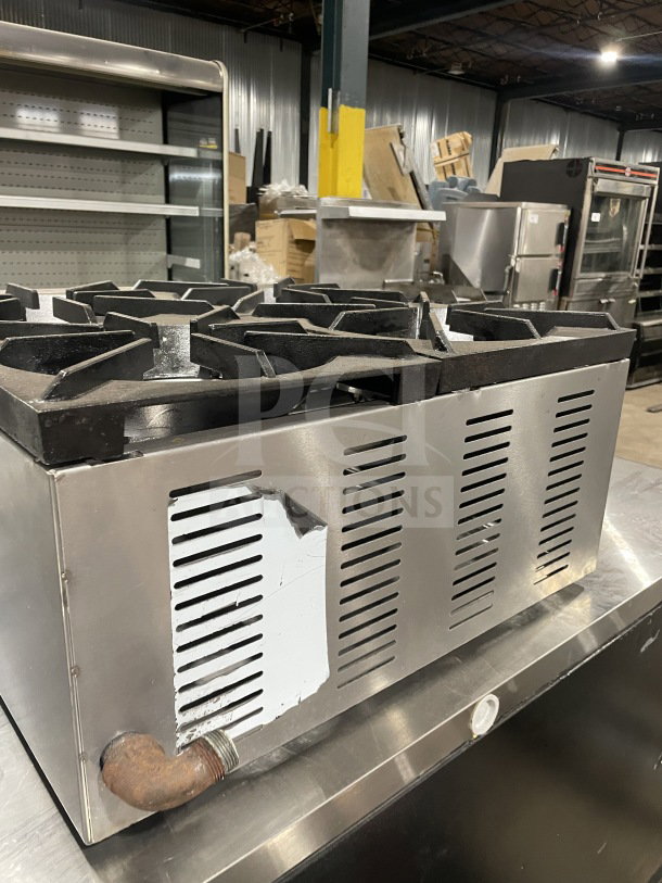 L&J Brands commercial stainless steel 4-burner countertop hot plate, gas powered, visible wear on metal exterior, auction item.