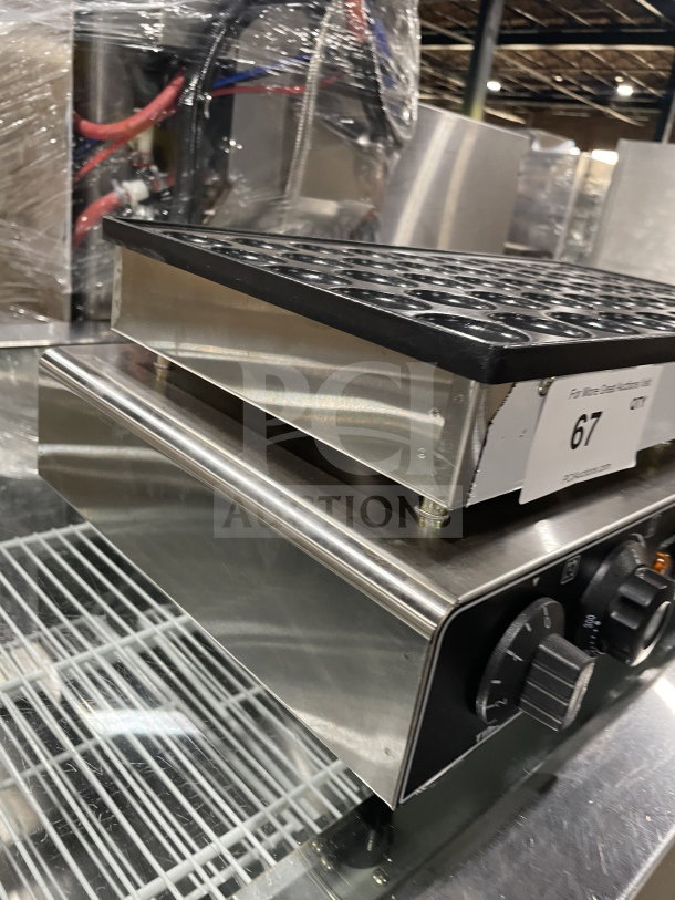 Commercial Electric 50-Hole Mini Pancake Maker in good condition, features sleek stainless steel and control dials.