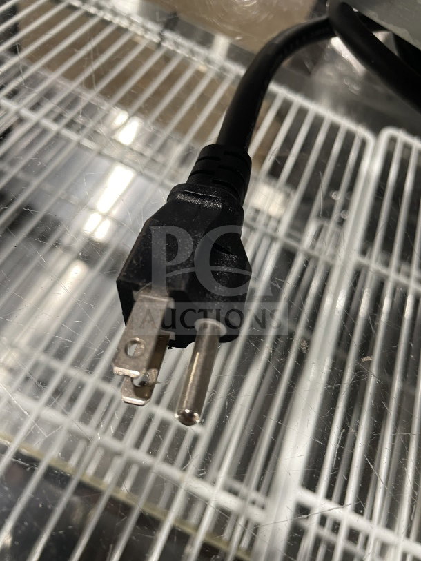 Electric plug of the Commercial Electric 50-hole mini pancake maker, highlighting its power cord connection.