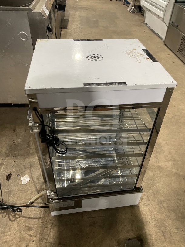 Commercial tabletop food steamer model ESTC-16 with glass panels and chrome-plated wire rack. Electric-powered, countertop design.