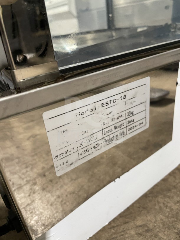 Commercial tabletop food steamer ESTC-16, electric-powered, glass construction, chrome-plated wire rack, label shows model details.