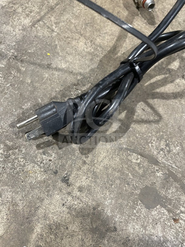 Power cord for the Commercial Tabletop Food Steamer, model ESTC-16, shown on a concrete surface.
