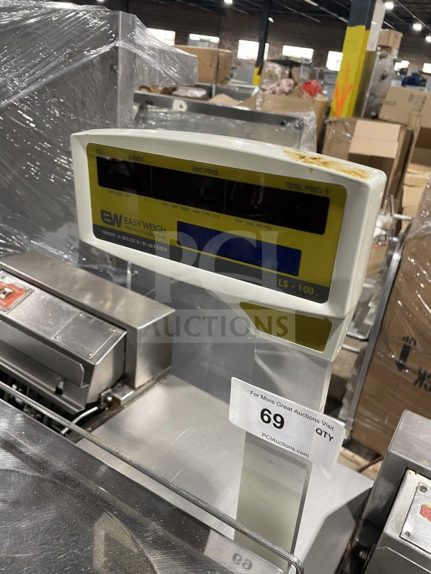 Easy Weigh LS-100 digital weight/price scale. Model: LS-100, SN: LS01150443, 85/240V, commercial countertop, visible wear.