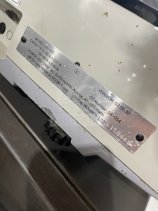 Easy Weigh LS-100 digital scale with label showing model, capacity 0-30 lb/0.01 lb, power 85/240V, SN LS01150443.