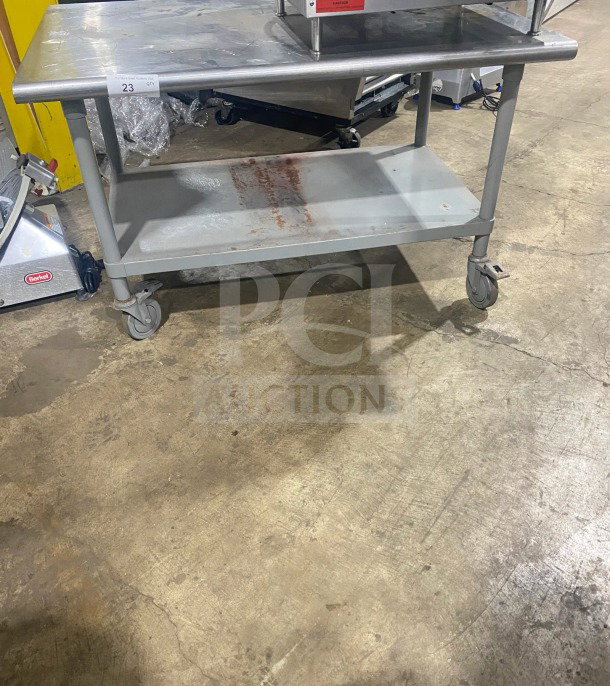 Commercial stainless steel two-compartment equipment stand on casters, maintained condition, includes shelf, visible label "23 QTY".