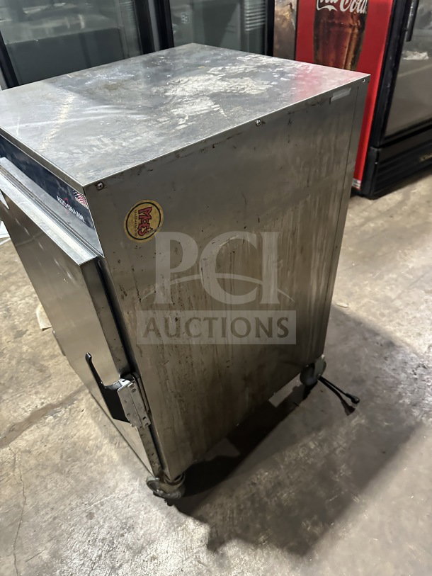 Alto Shaam 1200S stainless steel halo heat holding cabinet, SN M10673352021, visible wear, 120V, on casters for mobility.