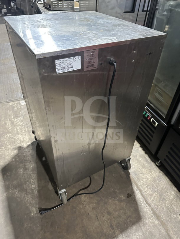 Alto Shaam stainless steel electric holding cabinet, model 1200S, on wheels with visible power cord and labels.