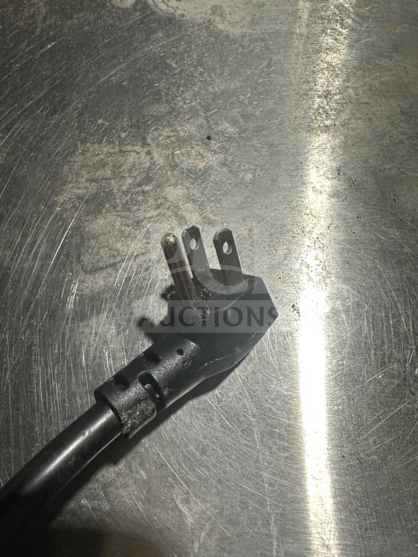 Broken power plug for Alto Shaam 1200S Halo Heat Holding Cabinet, shown on a metallic surface.