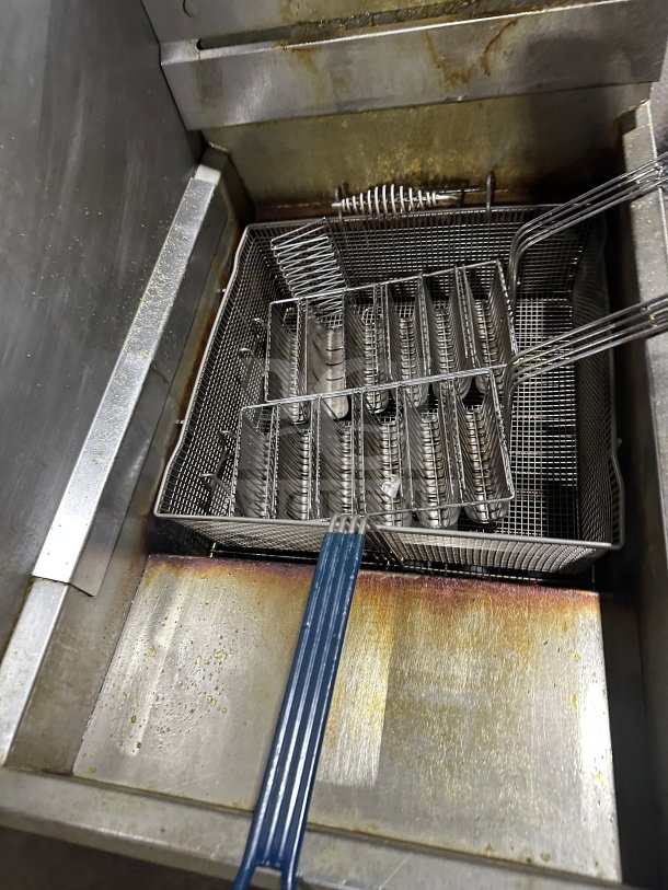 Pitco 65C+ stainless steel deep fat fryer with frying basket and backsplash, natural gas, on casters, used condition.