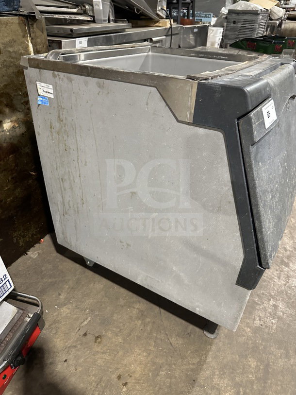 Scotsman B330P ice machine bin on legs, commercial-grade, air-cooled, electric, visible wear, identification tags shown.