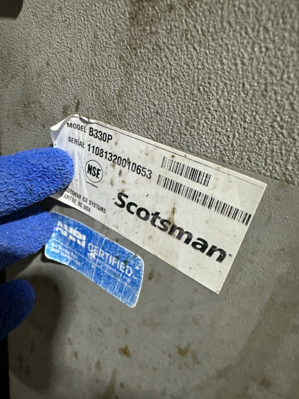 Scotsman B330P ice maker label with serial number 11081320010653, NSF certification, on air-cooled machine surface.