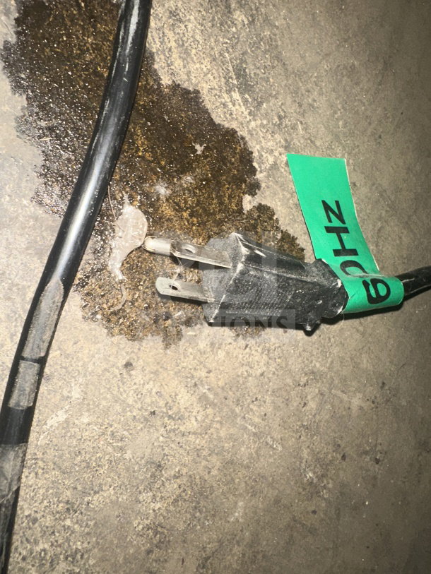 A 2019 Crathco model CS4E/2D/3D16 commercial beverage dispenser power cord on a concrete floor, labeled "ZH209."