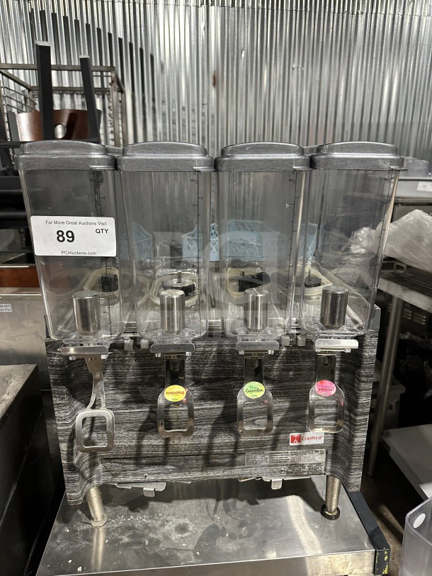 Crathco 2019 commercial countertop 4-hopper beverage dispenser, model CS4E/2D/3D16, with clear poly jugs and stainless steel body.