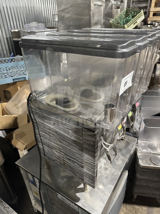 2019 Crathco CS4E/2D/3D16 beverage dispenser, 4 clear poly hoppers, stainless steel body, on legs, excellent condition.
