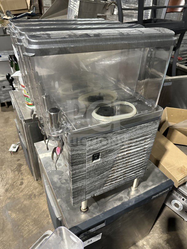 Crathco 2019 commercial beverage dispenser, model CS4E/2D/3D16, with 4 clear poly jugs, stainless steel body on legs.