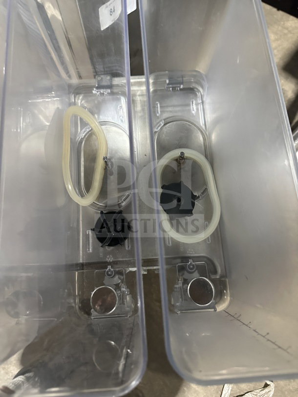 2019 Crathco CS4E/2D/3D16 beverage dispenser, four clear poly jugs, stainless steel body, on legs, 120V, visible internals.