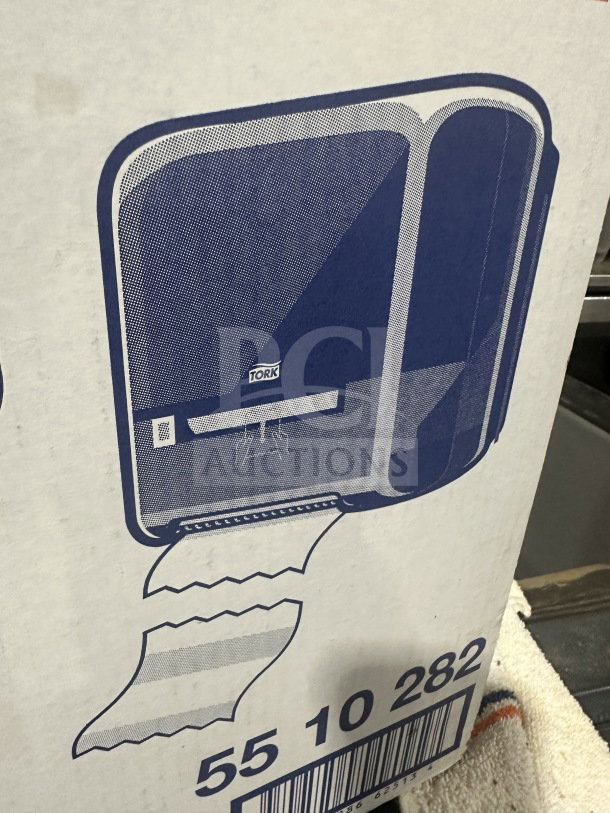 BRAND NEW Tork Matic Series black hand towel dispenser, model 302030, in original packaging with illustrated design.