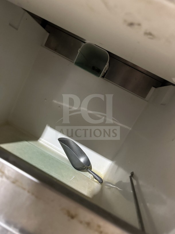 Manitowoc UNP0200A-161 undercounter ice machine interior, featuring stainless steel design and included ice scoop.