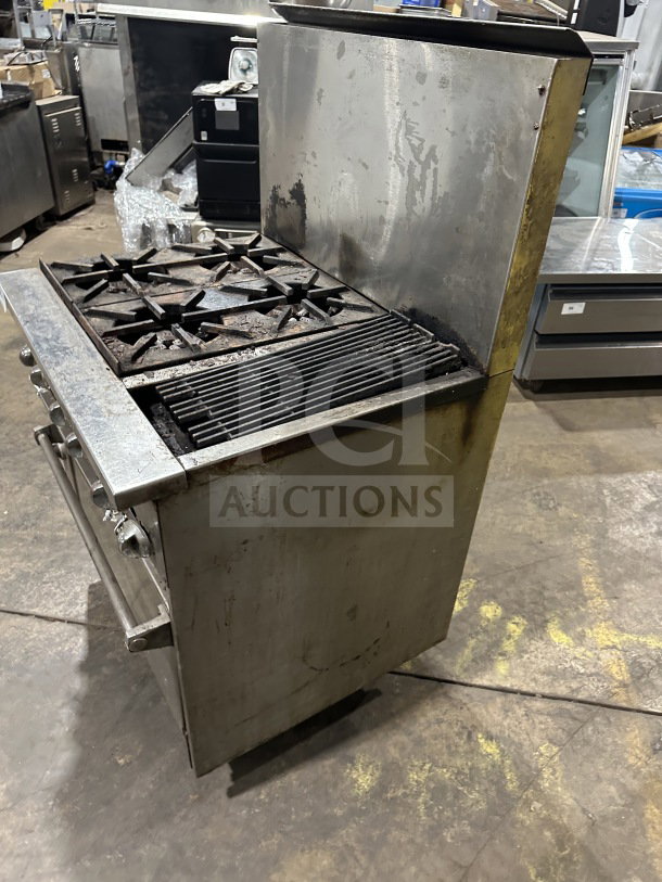 Commercial stainless steel gas range with 4 burners, 12" charbroiler, standard oven base, and wired rack on legs. Used condition.