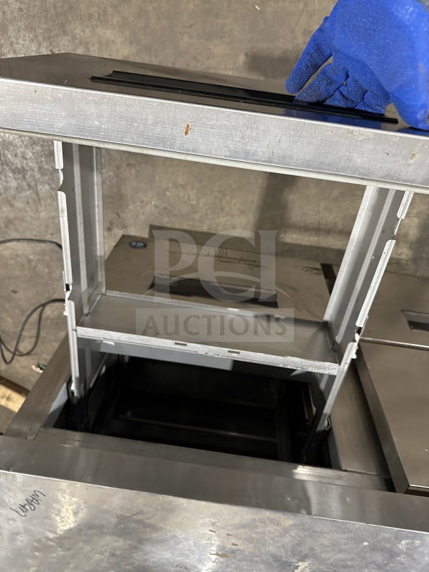 Hoshizaki stainless steel 4-drawer worktop freezer, model CRMF48-WD4, on casters. Visible wear on drawer edges.