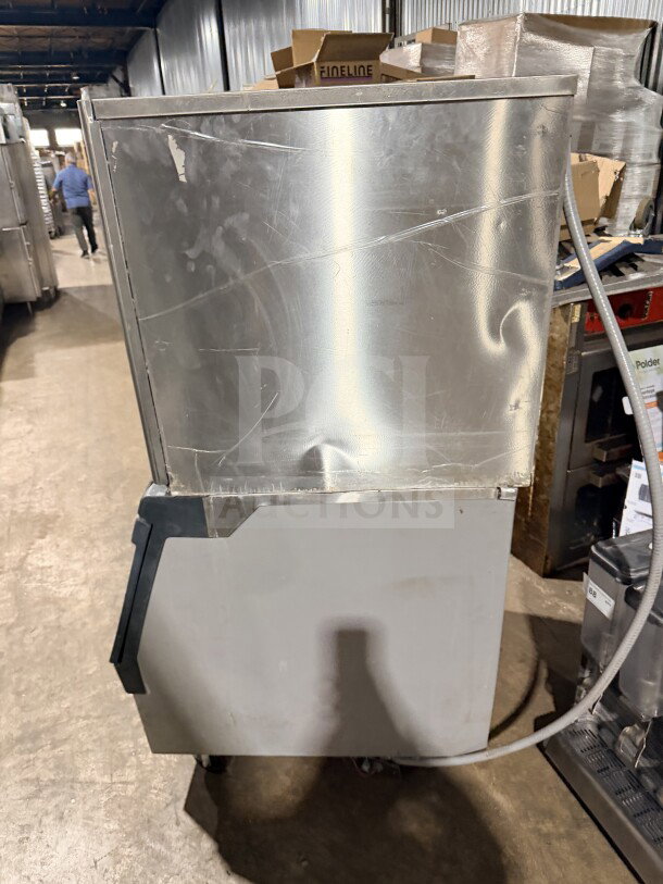 Hoshizaki stainless steel modular flake ice machine, model F-1001MAH, with insulated storage bin. 22" air-cooled, 208-230V, 1 phase. Visible wear.