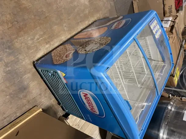 AHT RIO S100 ice cream display freezer, used, with Nestlé branding. 115V, 1 phase, on casters, showcases glass sliding lids.