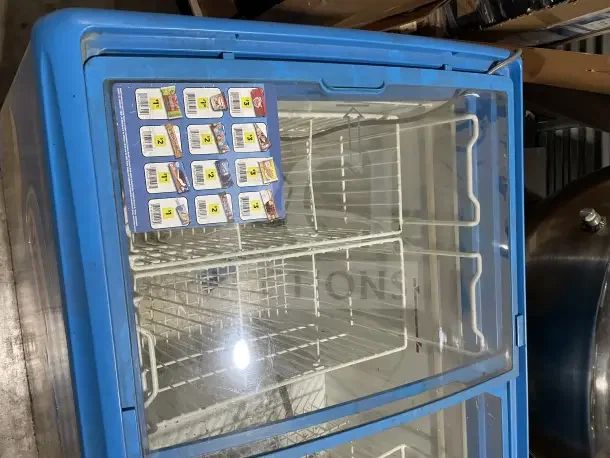 AHT RIO S100 commercial ice cream display freezer, 115V, on casters, glass top, interior baskets visible, used condition.