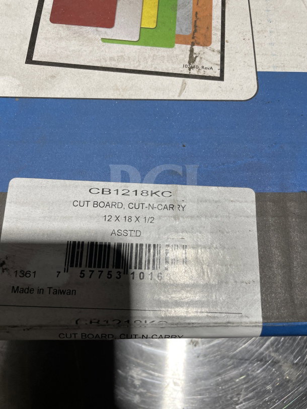 San Jamar CB1218KC Cut-N-Carry cutting board set, 12" x 18", assorted colors, visible label with barcode, made in Taiwan.