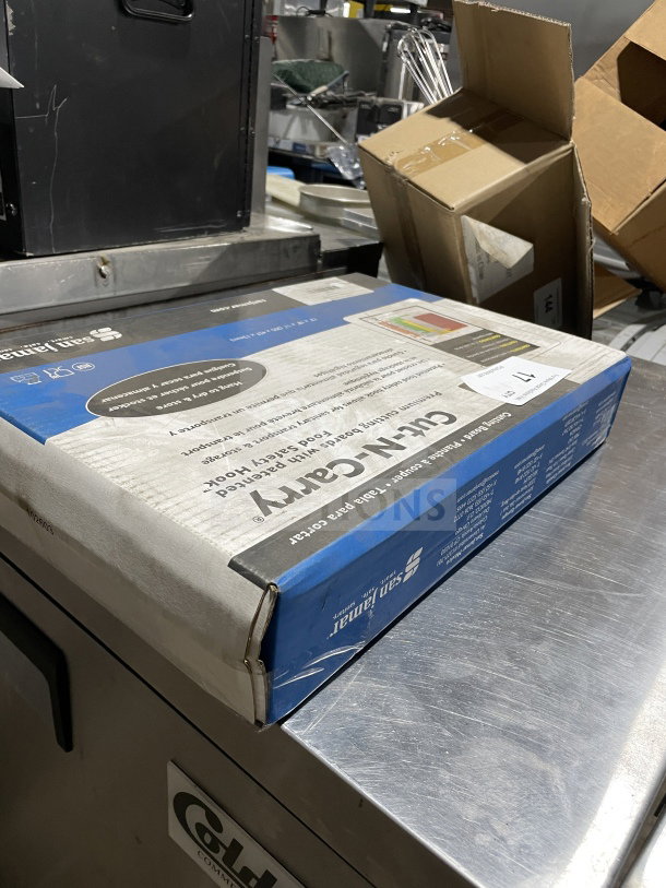 San Jamar Cut-N-Carry Cutting Board Set, Model CB1218KC, box of 6 boards, 12"x18", assorted colors, in packaging.