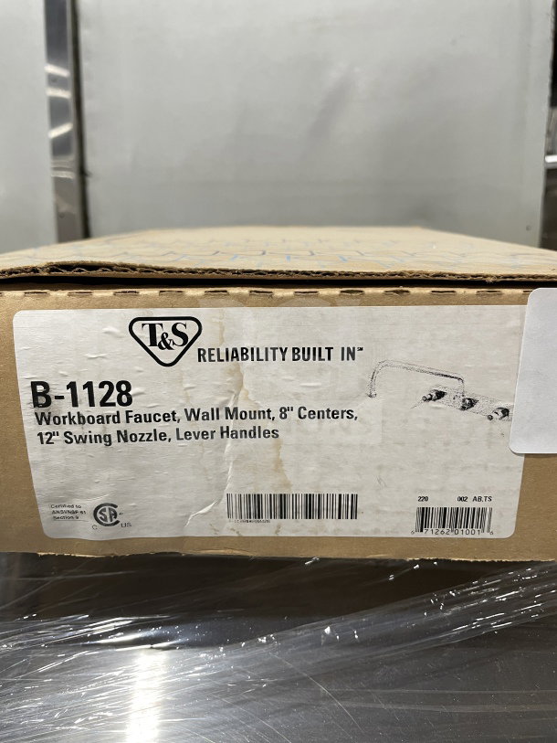 T&S B-1128 commercial wall-mounted workboard faucet, 8" centers, 12" swing nozzle, lever handles, in original box.