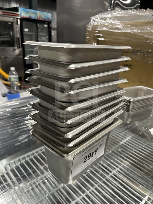 Stack of new Thunder Group STPA3192 1/9 size stainless steel steam table pans with anti-jamming corners, 2-1/2" deep.