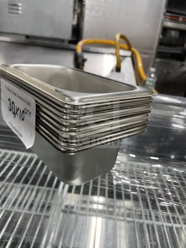 Amko stainless steel steam table pans with anti-jamming corners, new condition, packed in a stack.