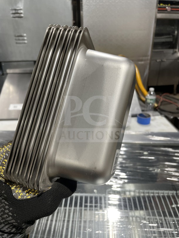NEW Amko stainless steel steam table pan set with anti-jamming corners, shown in a commercial setting.
