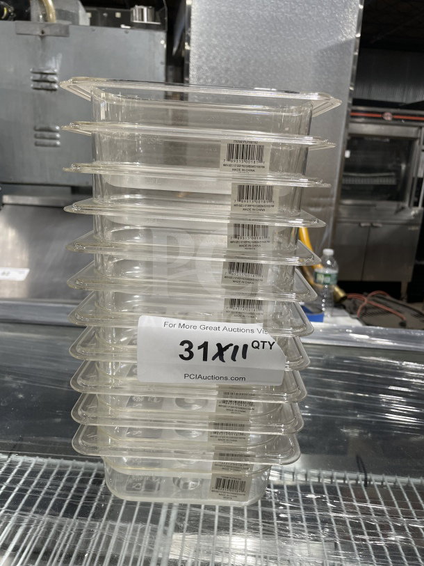 Stack of Thunder Group PLPA8192 polycarbonate food pans, new condition, clear with labels, 31 units available for auction.