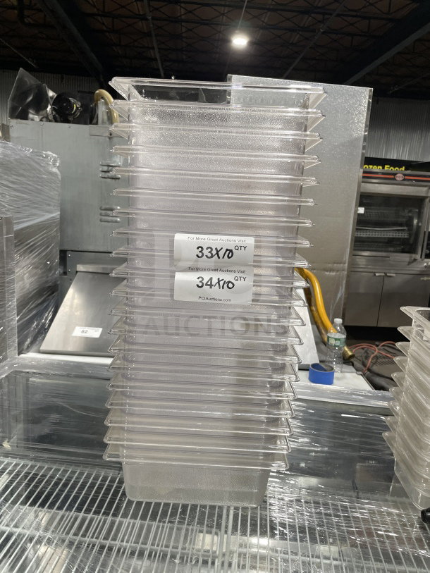Rubbermaid Commercial Model 3396 clear polycarbonate deep food pan, stack of multiple units, visible auction tags.